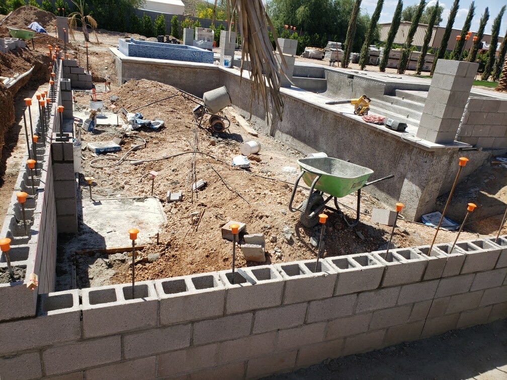 Aurora Estate — corner of the new block wall with rebar grouted in place looking back toward the raised spa and pool structure