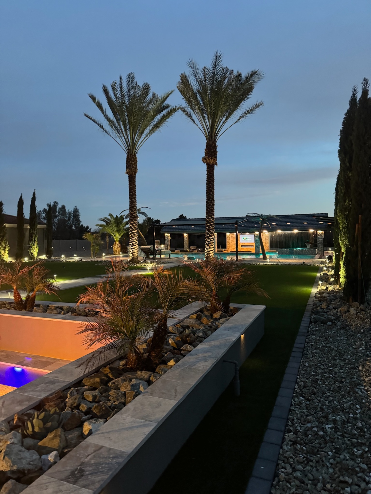 Aurora Estate — wide twilight view across lawn and pavilion