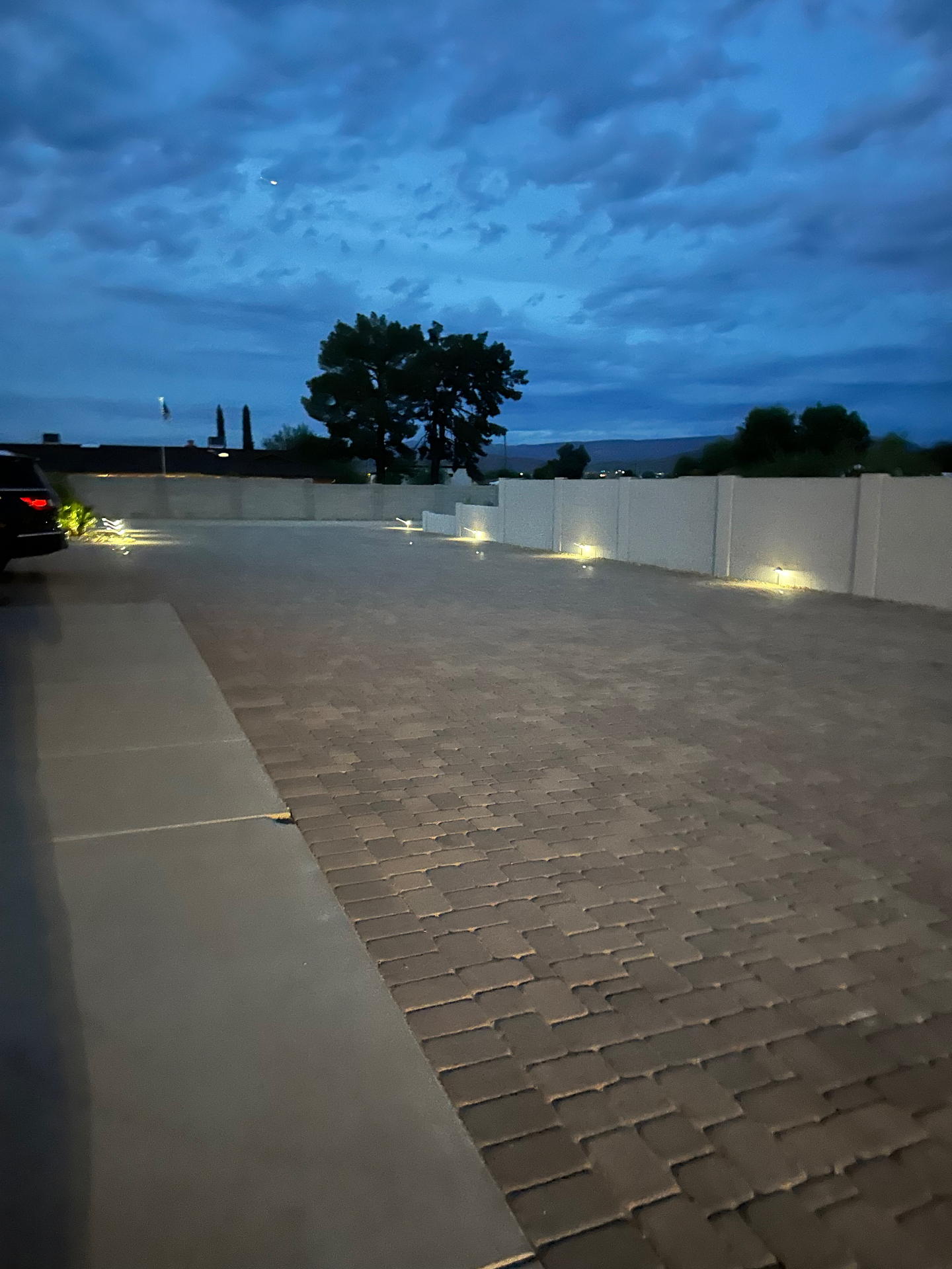 Aurora Estate — extended paver RV pad along block wall at twilight