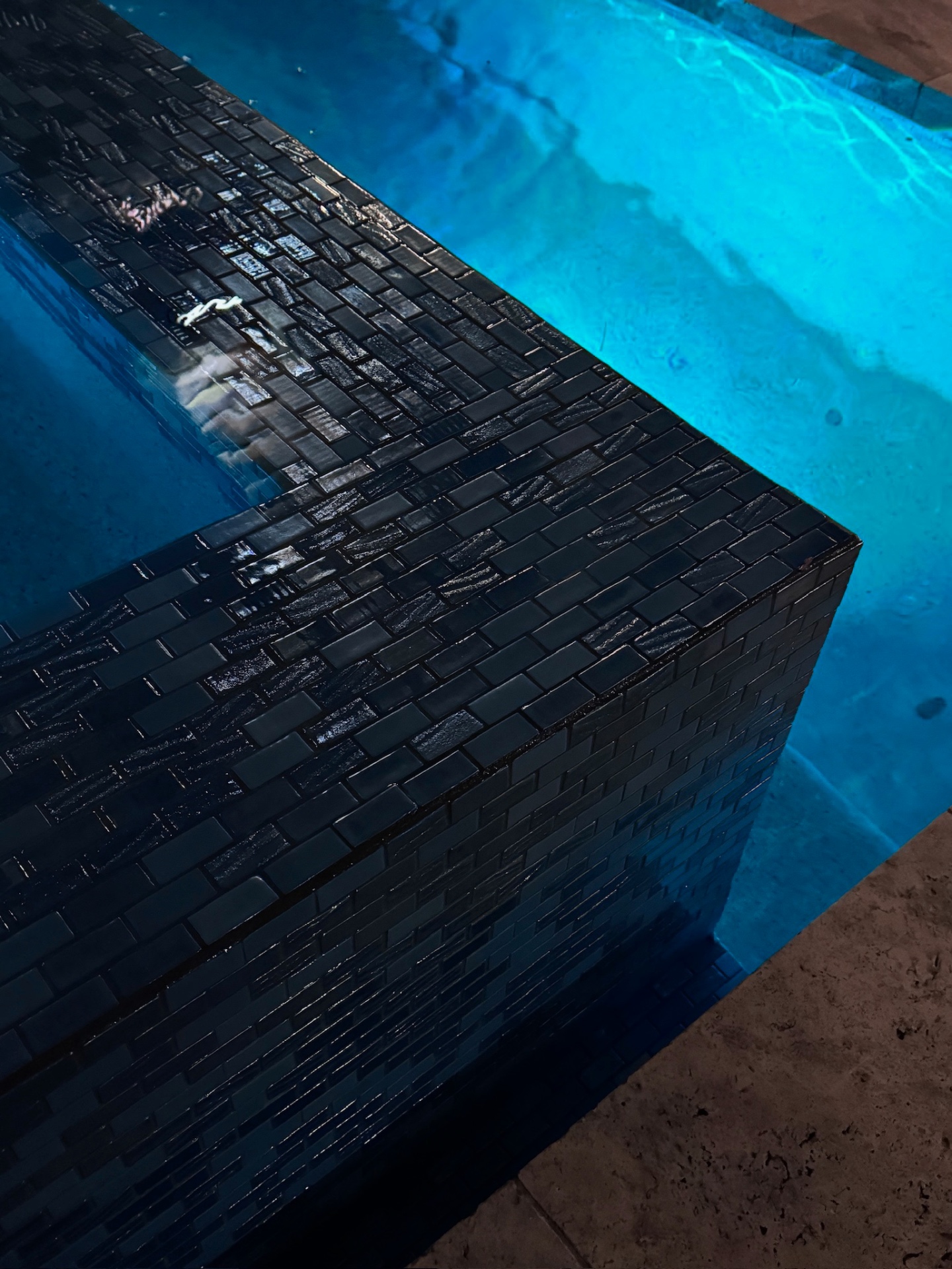 Aurora Estate — iridescent black glass mosaic tile vanishing edge detail