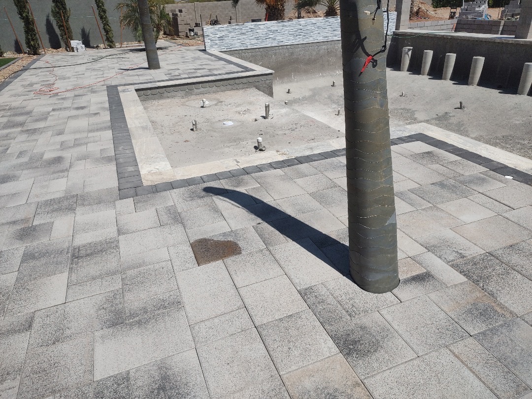 Aurora Estate — close view of the deck pavers with charcoal banding wrapping the sun shelf and travertine inset detail