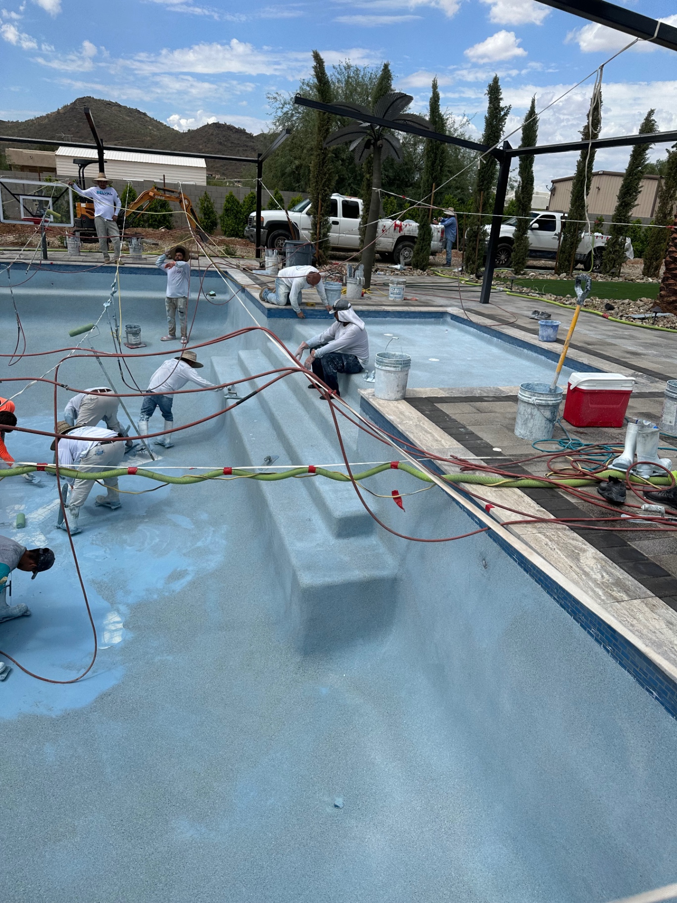 Aurora Estate — pebble finish applied around the pool steps, tanning ledge and raised spa wall during interior install