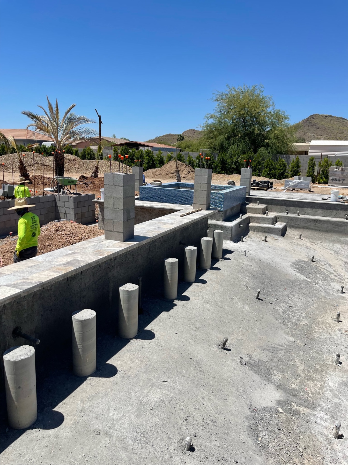 Aurora Estate — raised spa, pool shell, and structural column blockouts aligned together before finish interior and final site cleanup